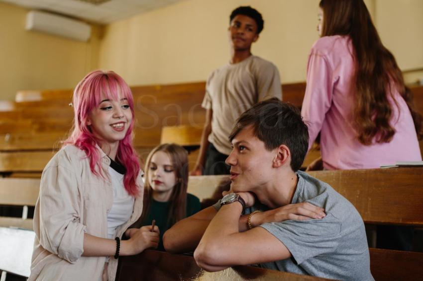 group of young students socializing in a classroom