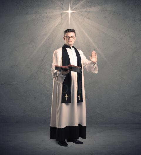 a young male priest in black and white giving his