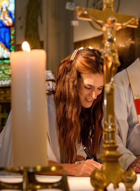 beautiful bride signing marriage certificate in